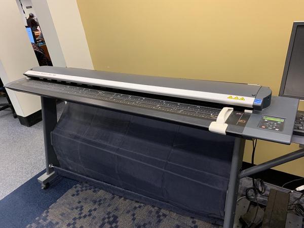 Large format scanner, which is a few feet off the ground and several feet long