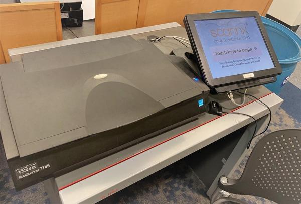 Book scanner on a table with a touch screen